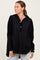 woman wearing a black oversized hoodie with a button-up neckline and front pockets