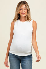 woman wearing a white sleeveless ribbed maternity top and showing her baby bump