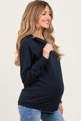 woman wearing a black long sleeve maternity hoodie and showing her baby bump