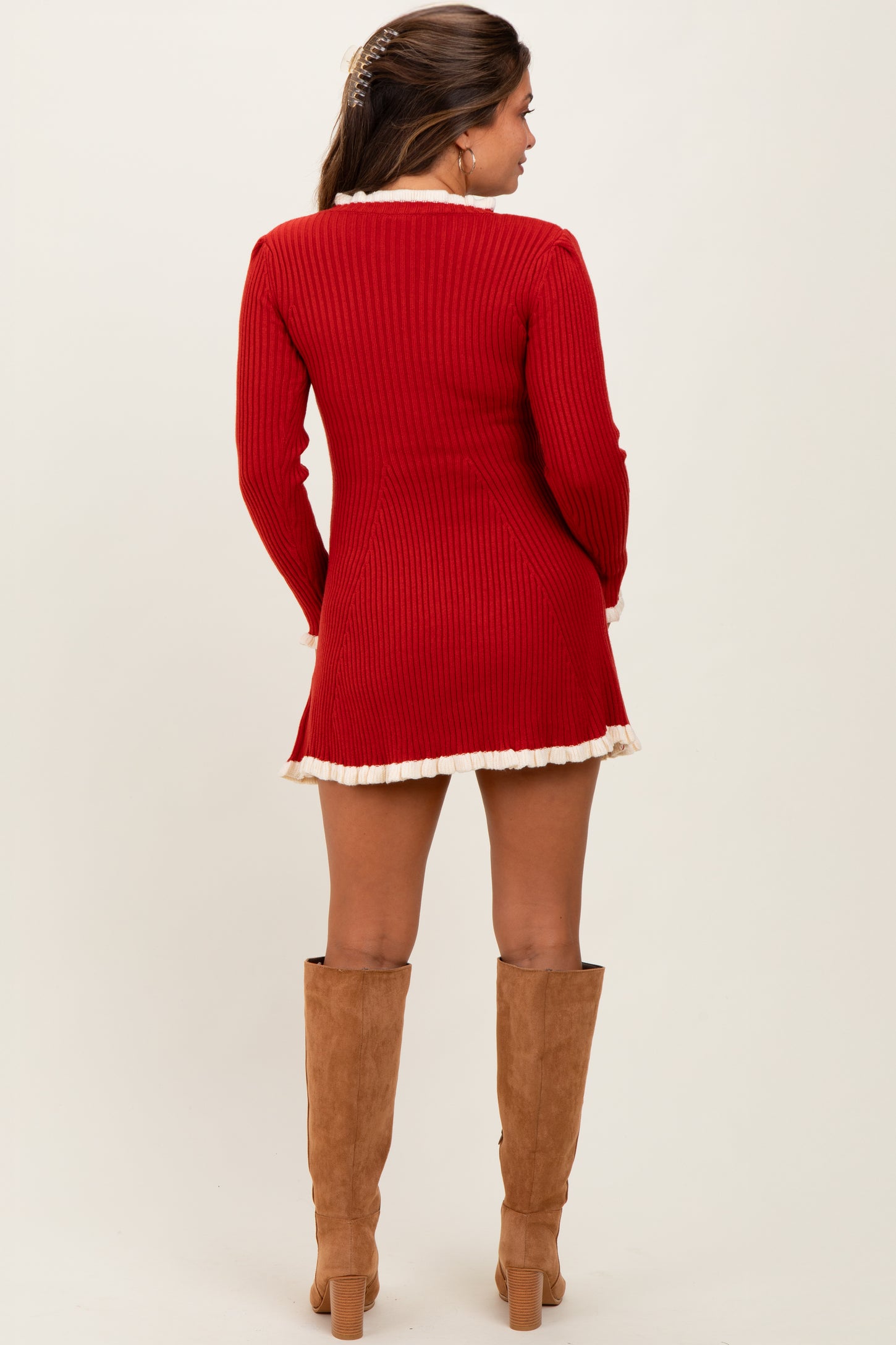 woman wearing a red ribbed maternity dress with a flared hem and long sleeves