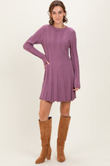 woman wearing a ribbed lilac long sleeve dress paired with knee-high brown suede boots