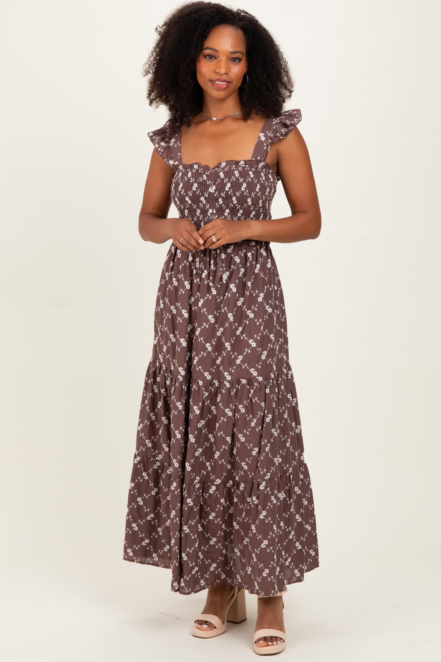 woman wearing a brown floral maxi dress with ruffled straps and a smocked bodice