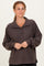 woman wearing a dark brown fleece pullover with a buttoned neckline and long sleeves