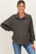 woman wearing a dark green button-up maternity pullover top with long sleeves and a relaxed fit