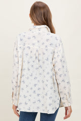 woman wearing a cream floral print maternity blouse with long sleeves and a loose fit, showing a relaxed back detail