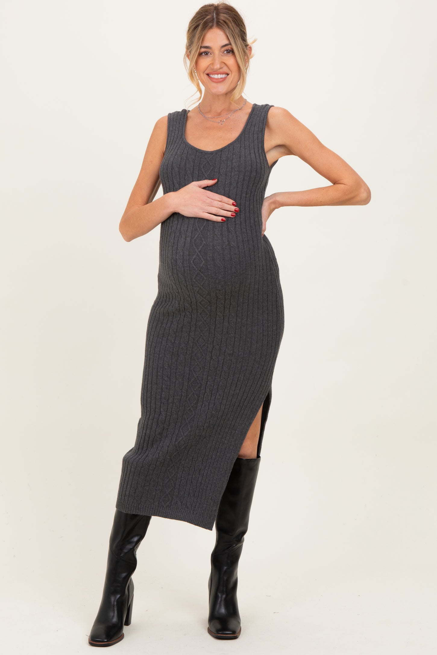woman wearing a gray ribbed maternity dress with side slit and holding her baby bump