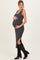 woman wearing a gray ribbed maternity dress with side slits and a baby bump, paired with black knee-high boots