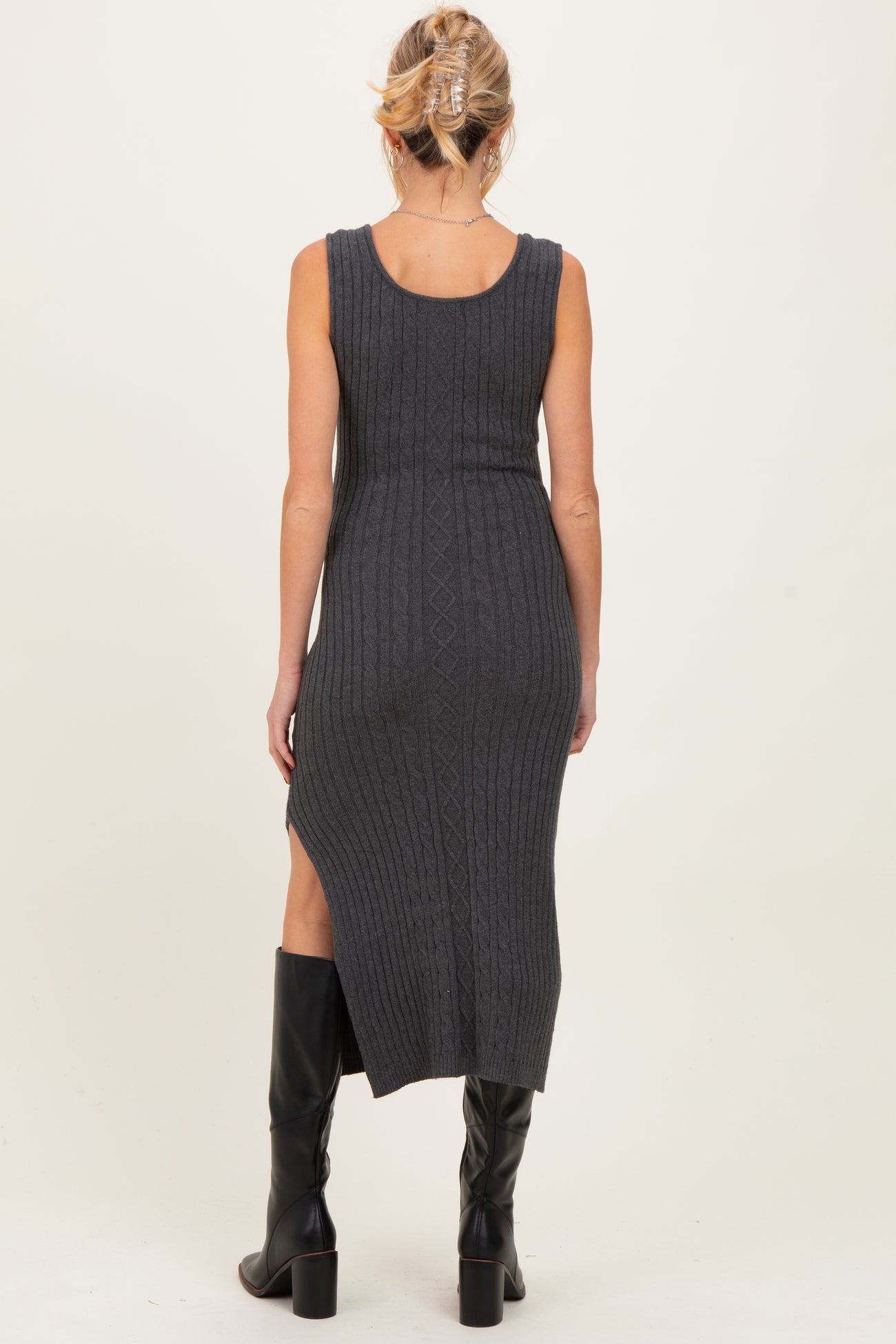 woman wearing a dark gray ribbed maternity maxi dress with a side slit, showing her baby bump from the back