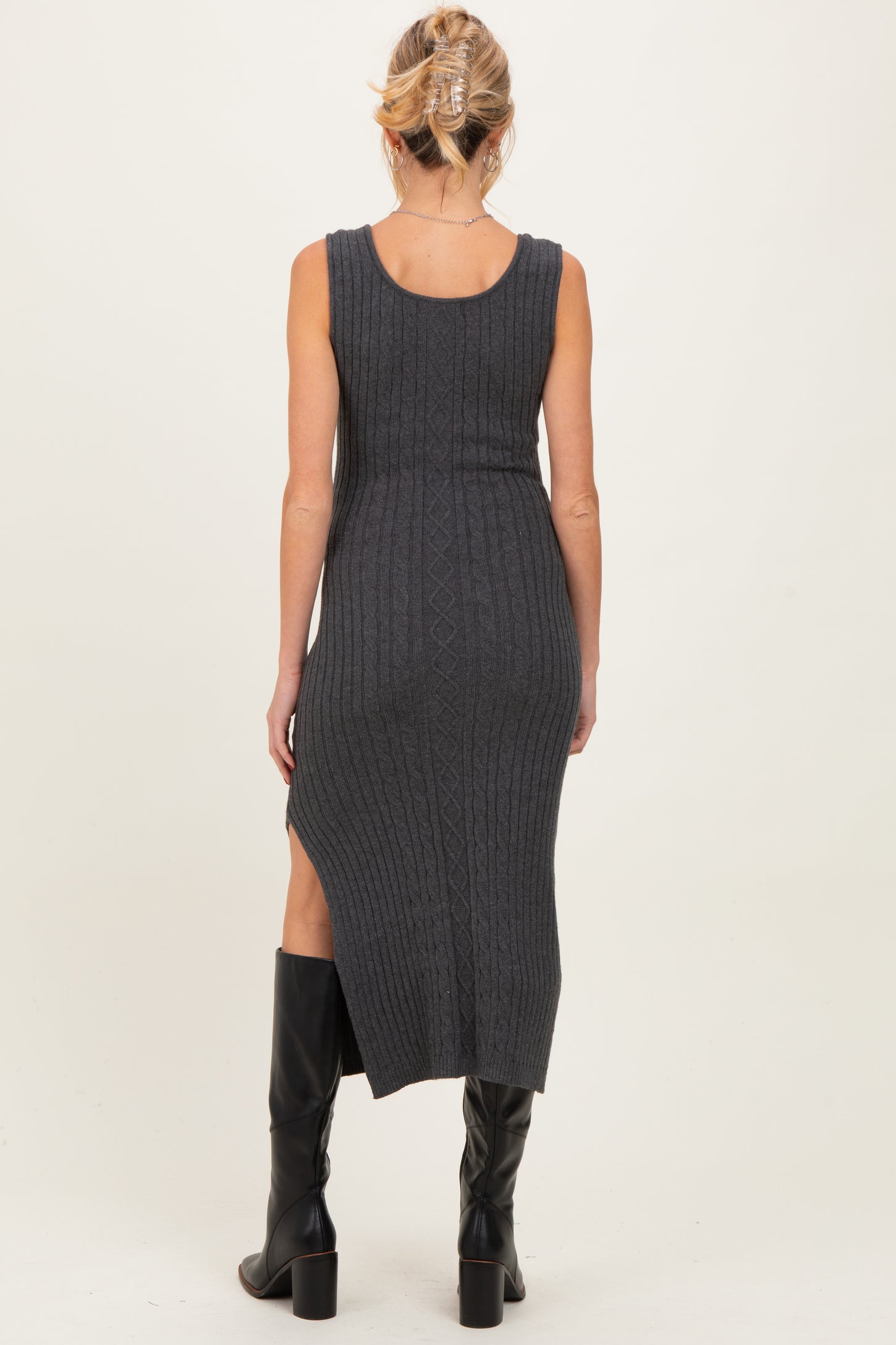 woman wearing a dark gray ribbed maternity maxi dress with a side slit, showing her baby bump from the back