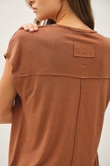 woman wearing a rust brown short sleeve top with a back yoke detail and patch pocket