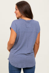 woman wearing a blue short sleeve maternity top with a back yoke detail and relaxed fit
