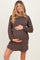 woman wearing a brown ribbed maternity dress and holding her baby bump