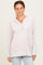 woman wearing a pink and white striped hooded pullover with a button detail and gray sleeves