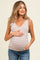 woman wearing a beige and white striped maternity tank top with bow details, showing her baby bump