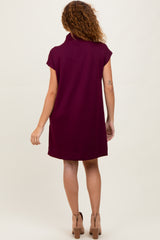 woman wearing a burgundy short sleeve dress with a collar and a relaxed fit, shown from the back