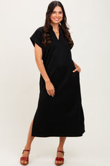 woman wearing a black short sleeve maxi dress with a v-neck and side pockets