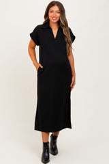 woman wearing a black short sleeve maternity dress with a collar and side pockets, showcasing her baby bump