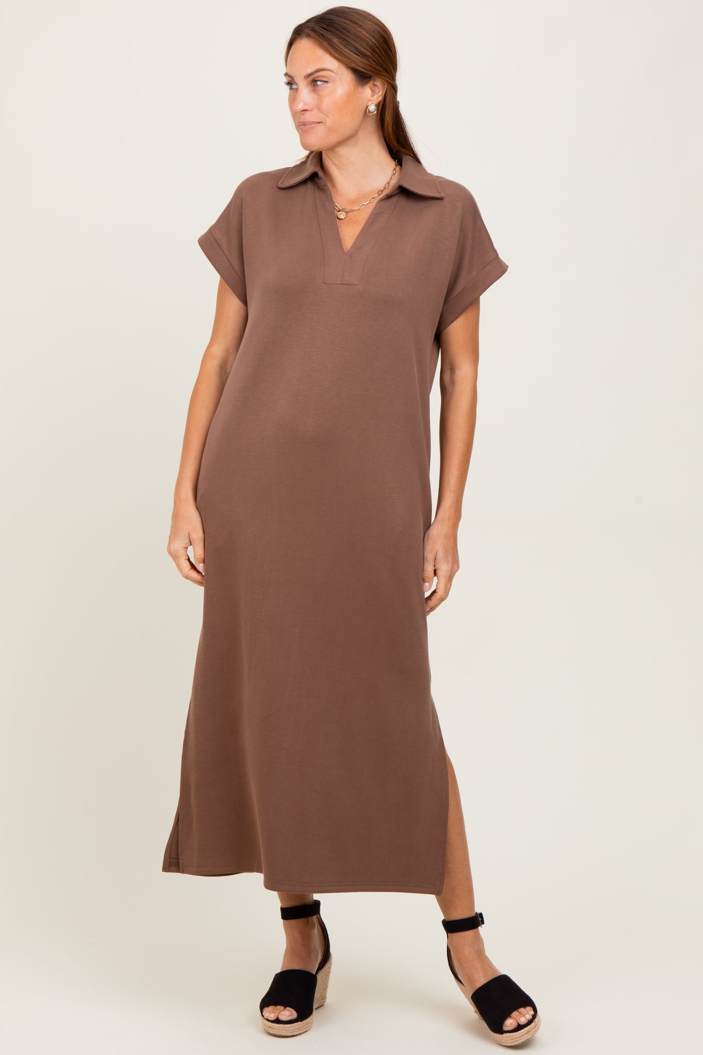 woman wearing a brown short sleeve maxi dress with a collar and side slits