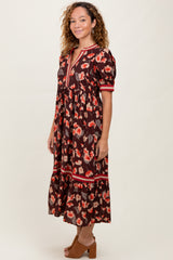 woman wearing a brown floral midi dress with puff sleeves and a v-neckline, standing sideways on a neutral background