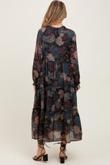 woman wearing a flowy long sleeve floral maternity dress with a tiered skirt and a gathered neckline, styled with heeled sandals