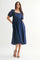 woman wearing a navy blue midi dress with puff sleeves and a square neckline, styled with black heels