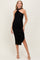 woman wearing a black halter neck maternity dress with ruching and a side slit, showcasing her baby bump
