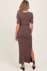 woman wearing a brown ribbed maternity maxi dress with a side slit and short sleeves, showcasing her baby bump