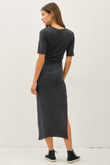woman wearing a charcoal gray midi dress with short sleeves and a side slit, viewed from the back