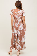 woman wearing a brown floral maxi dress with short sleeves and an elastic waist, seen from the back