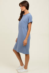 woman wearing a light blue ribbed short sleeve dress with a pocket and white sneakers