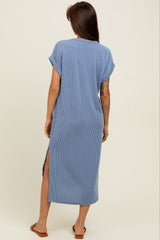 woman wearing a light blue striped maternity maxi dress with short rolled sleeves and side slits