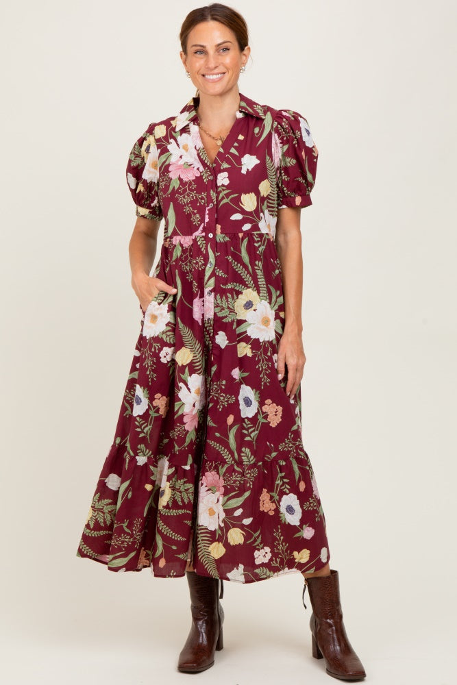 woman wearing a burgundy floral maxi dress with puff sleeves and button details, paired with brown ankle boots
