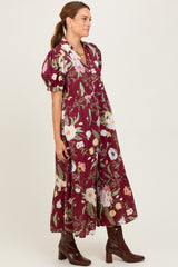 woman wearing a burgundy floral maxi dress with puff sleeves and ankle boots