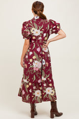 woman wearing a burgundy floral maxi dress with puff sleeves and a tiered hem