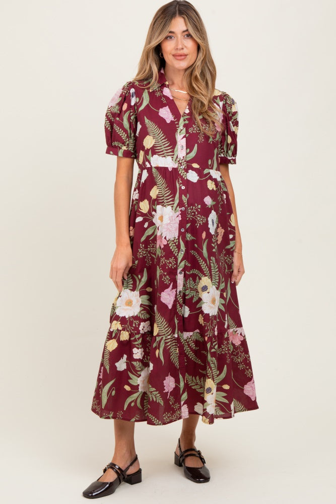 woman wearing a burgundy floral maternity dress with puff sleeves and a button-down front