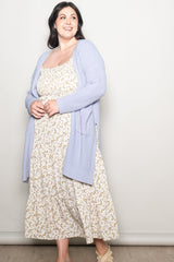 woman wearing a light purple cardigan over a floral maxi dress in a plus size fit