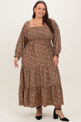 woman wearing a brown floral plus size maxi dress with smocked bodice and long puff sleeves