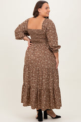 woman wearing a brown floral maxi dress with puff sleeves and a smocked bodice, showing the back view