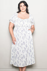 woman wearing a white floral plus-size midi dress with short puff sleeves and pockets