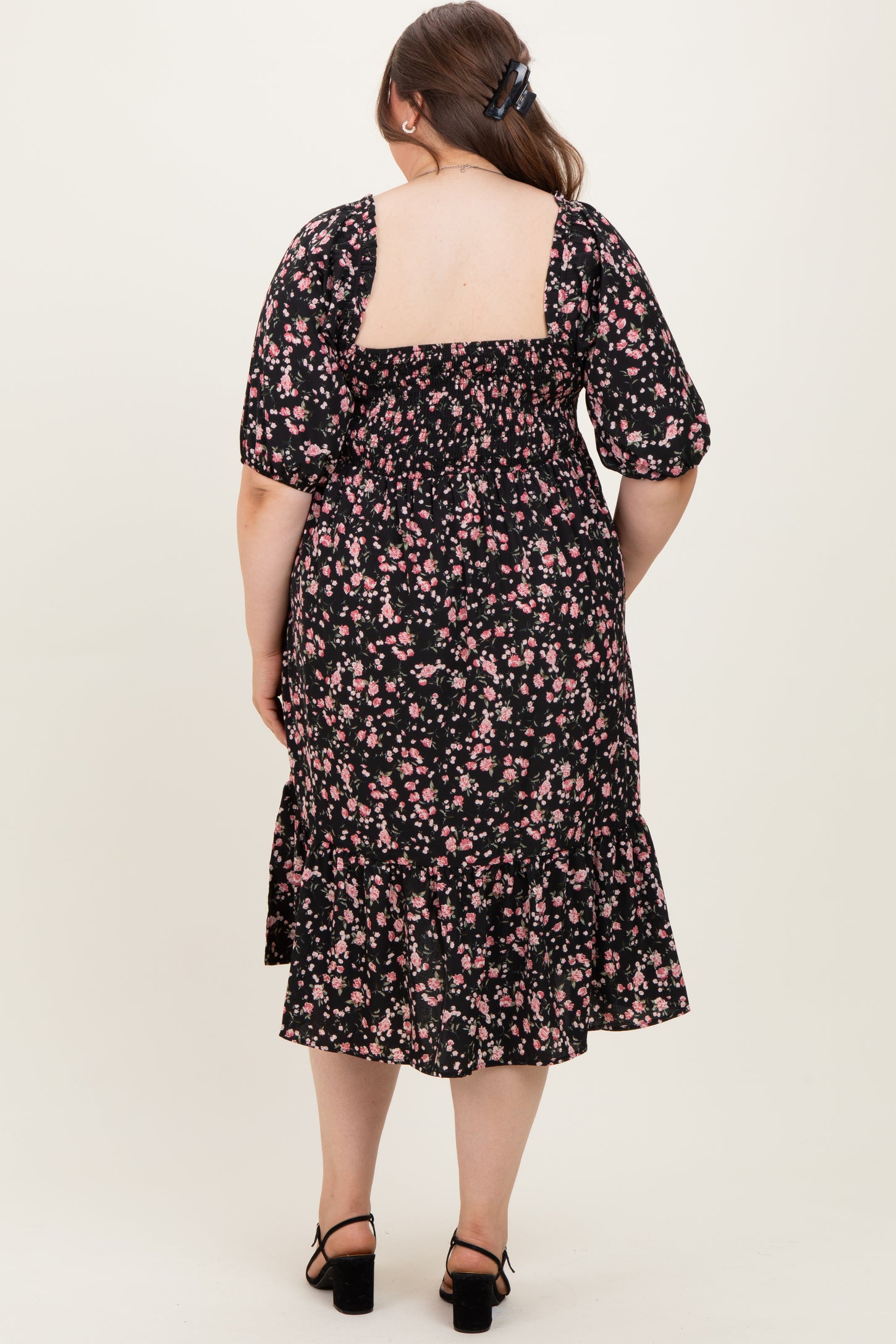 maternity wear black floral print midi dress with puff sleeves and a ruffled hem, model shown from the back