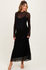 woman wearing a black lace maternity dress with long sleeves and a fitted silhouette, showcasing her baby bump