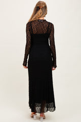 woman wearing a long black lace maternity dress with long sleeves and a fitted silhouette, showing a baby bump