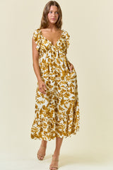 woman wearing a white floral midi dress with ruffle details and pockets, standing against a light background