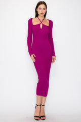 woman wearing a fuchsia long sleeve midi dress with a keyhole detail and a figure-hugging fit