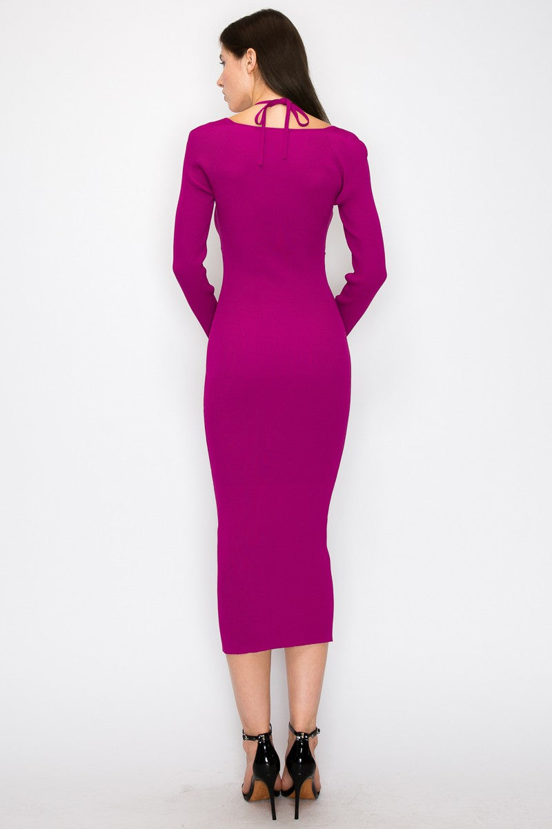 woman wearing a fitted hot pink long sleeve dress with a tie detail at the back
