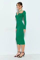 woman wearing a fitted green ribbed midi dress with long sleeves and a crisscross neckline detail