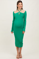 woman wearing a green ribbed long sleeve maternity dress with a keyhole cutout and a visible baby bump