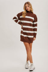 woman wearing a brown and white striped oversized sweater dress with a high neckline and long sleeves