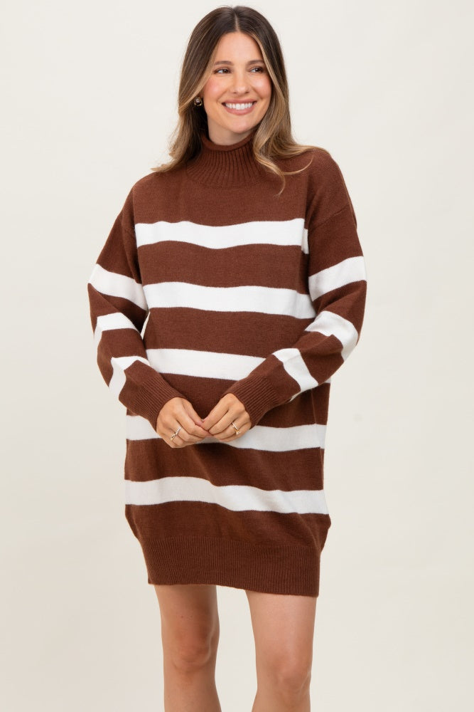 woman wearing a brown and white striped maternity sweater dress with a high neckline and relaxed fit
