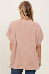 woman wearing a beige striped short sleeve top, showcasing a relaxed fit and back view